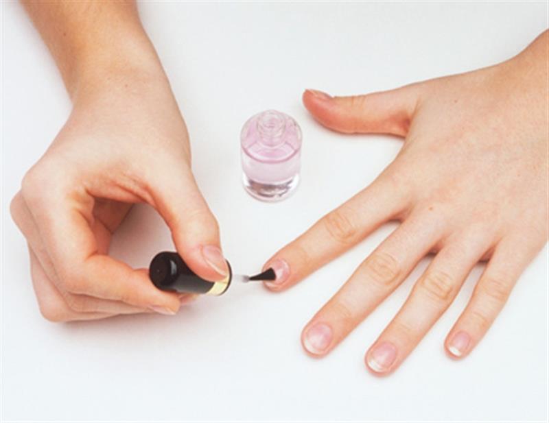 Applying base coat to nails