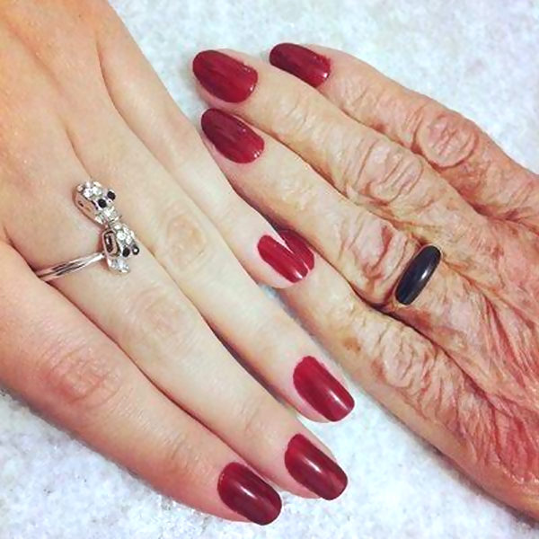 Red polish on old and young hands
