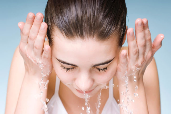 Washing face with cold water