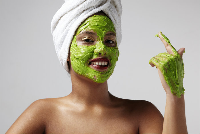 Woman using avocado face mask