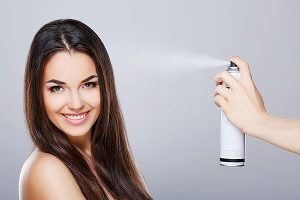 Spraying heat protection on hair